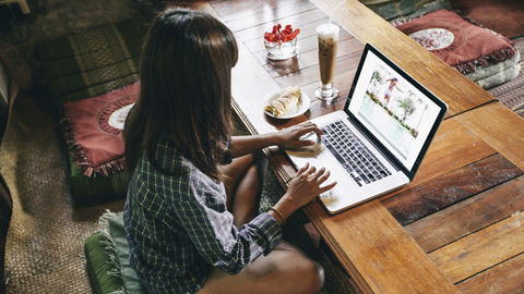 Woman working with photos on her laptop