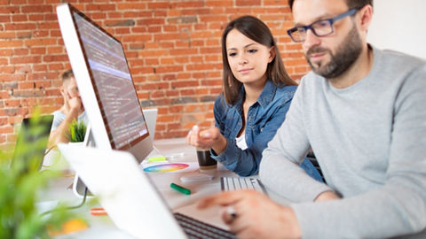 Young man and woman web developers programming and coding