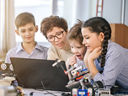 Family with young children using a laptop together
