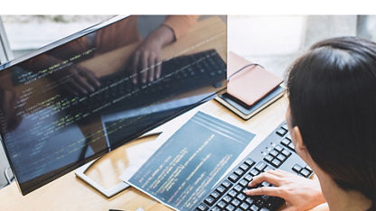 A tight overhead shot shows a person coding at an office desk
