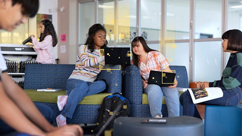 Students collaborating with laptops