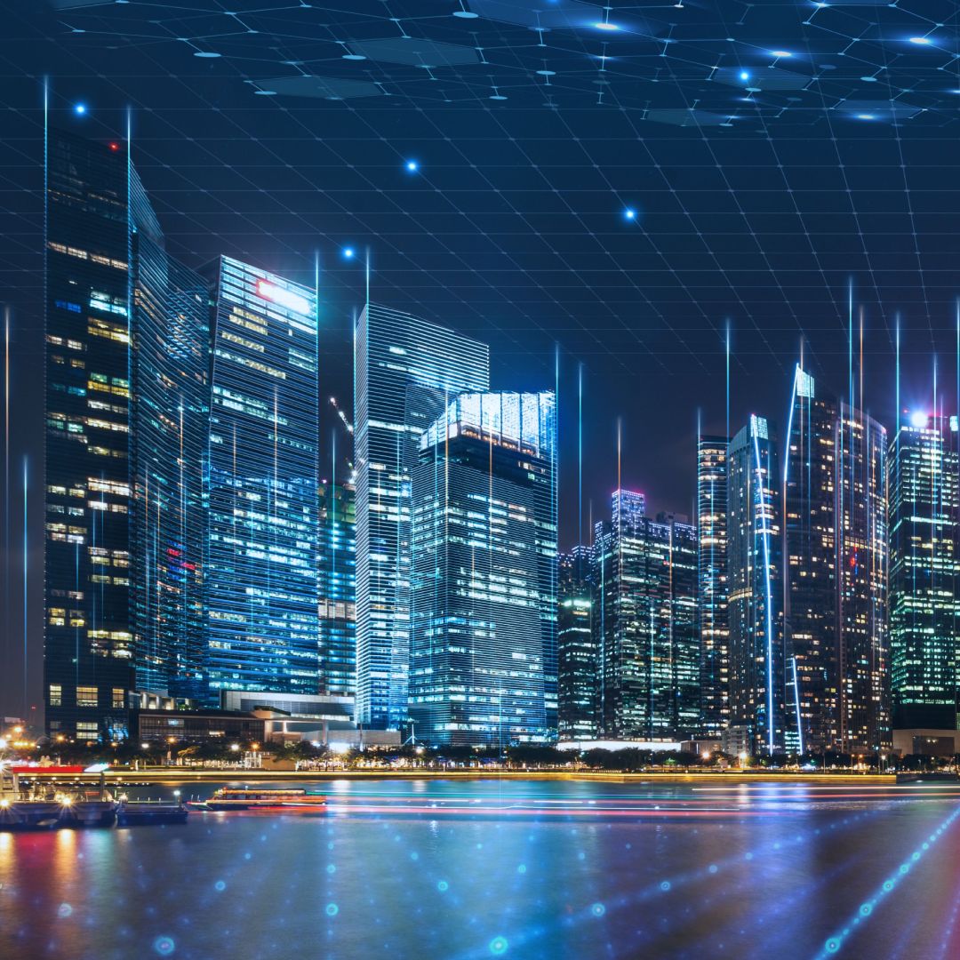 City skyline at night overlaid with a digital grid and connected data network.