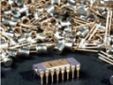 The Intel® 4004 Chip in front of hundreds of transistors