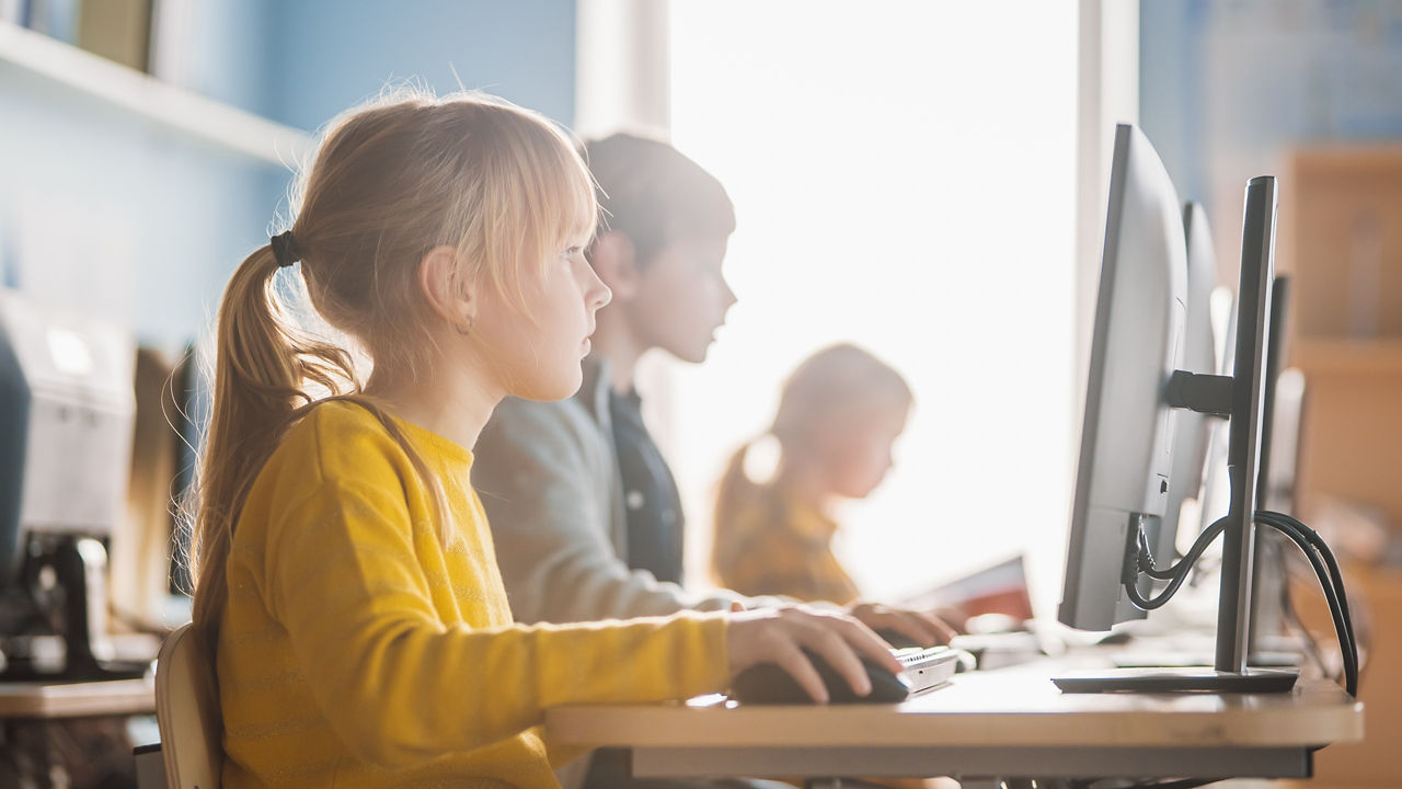 This image contains 16x9, 4x3 and 1x1 JPGs renditions suitable for online and social media. Elementary school age kids using computers in class computer lab. Derived from IDL