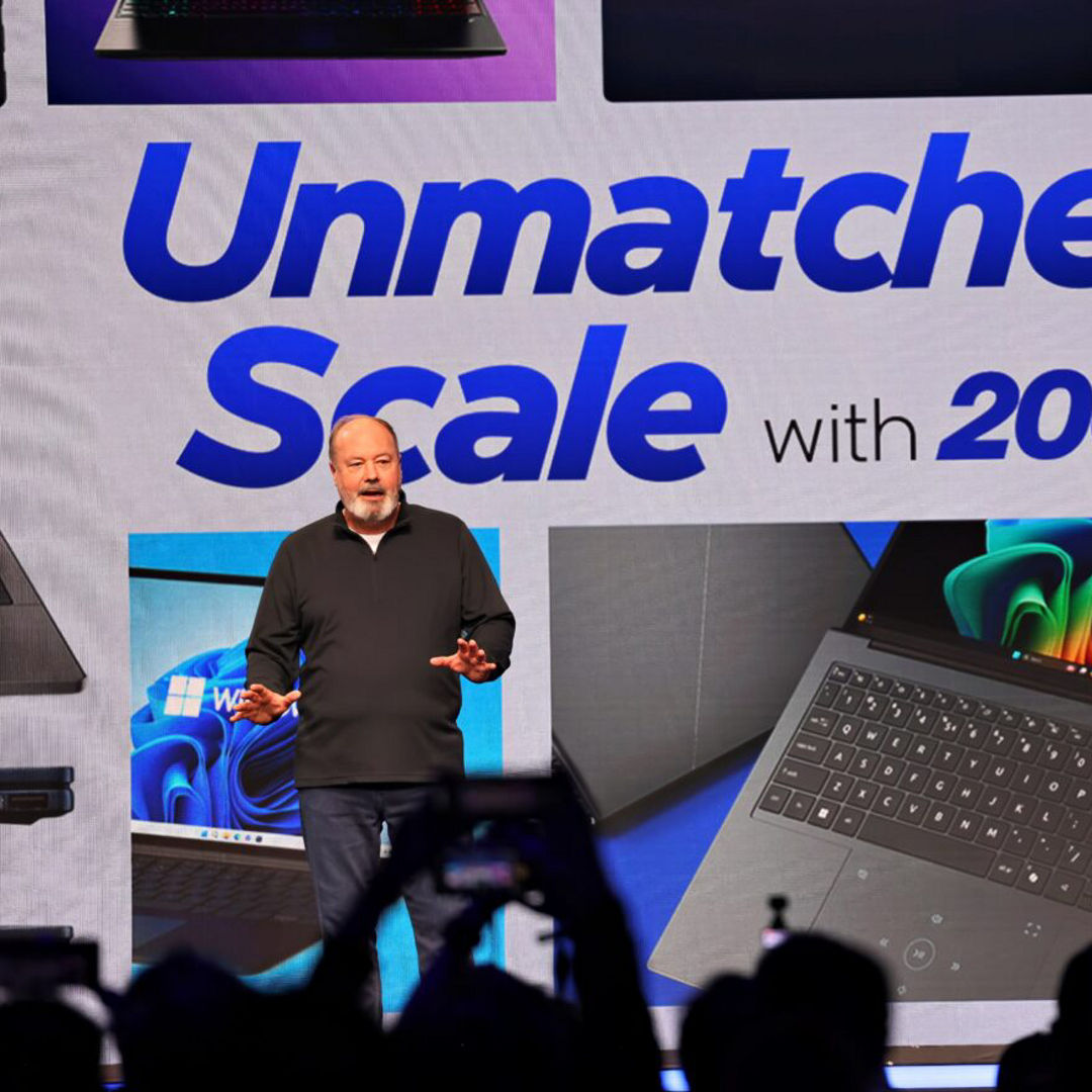 Presenter onstage with a Microsoft partner presentation.