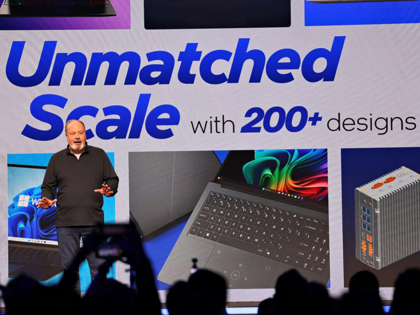 Presenter onstage with a Microsoft partner presentation.