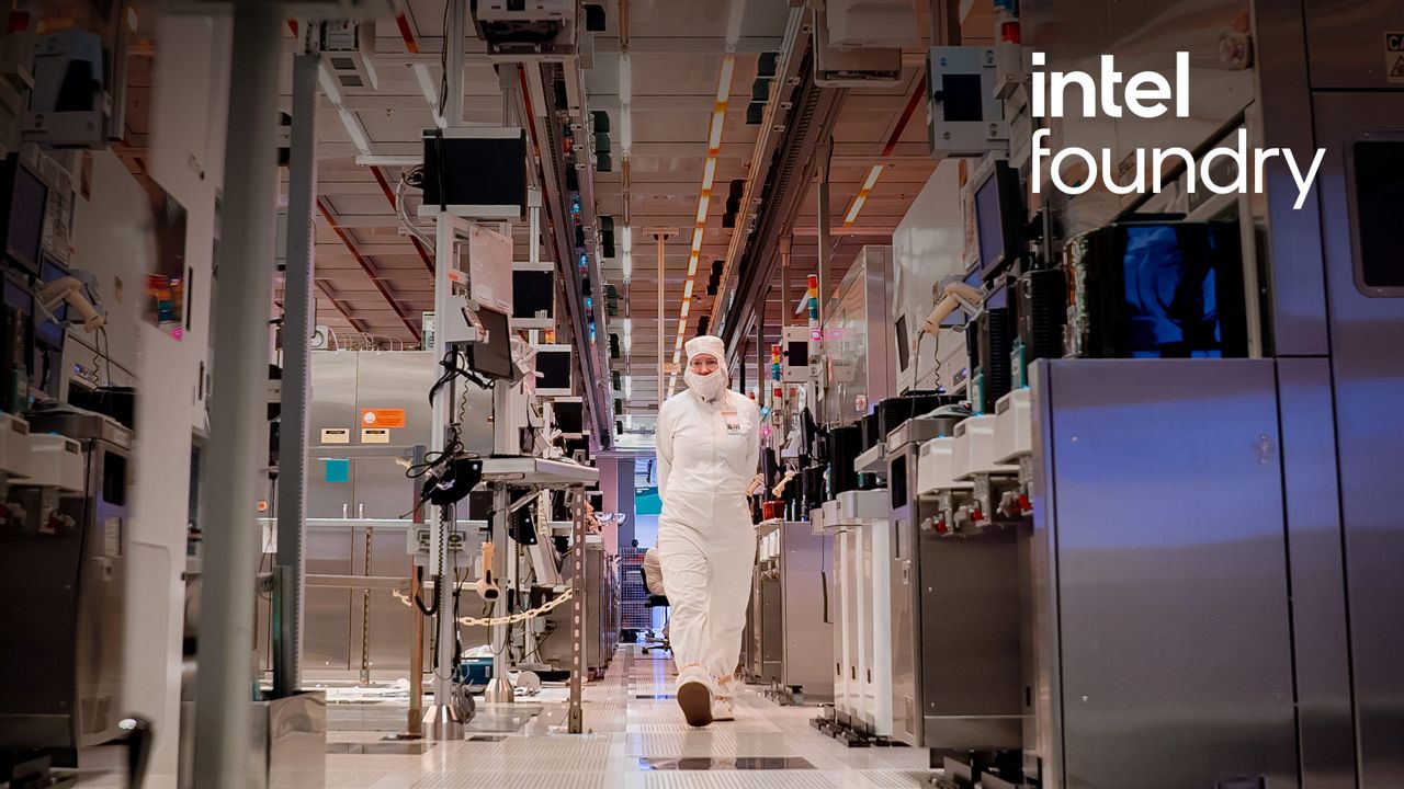 Person wearing a clean suit walking down the aisle of a factory