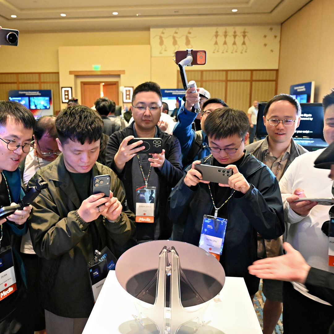 Attendees photograph an Intel Core Ultra series 3 wafer.