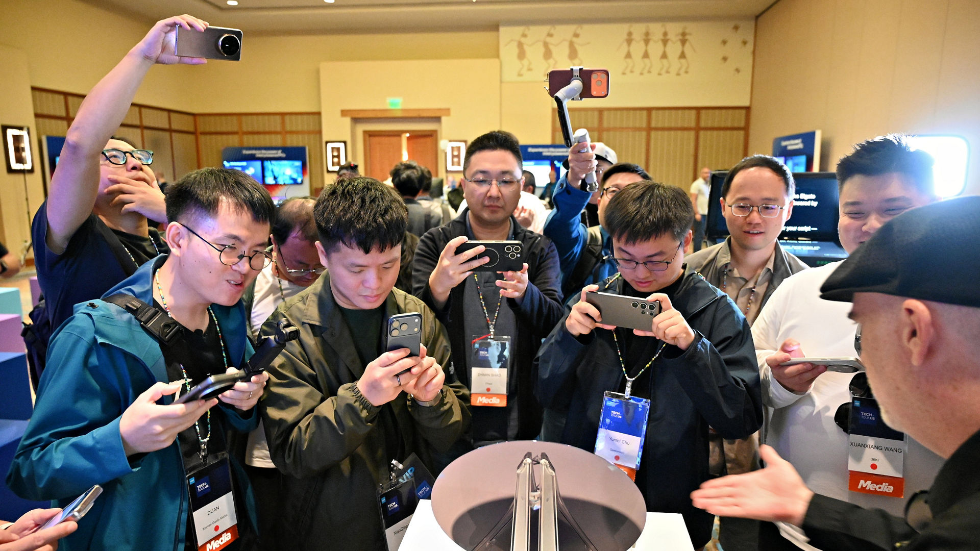 Attendees photograph an Intel Core Ultra series 3 wafer.