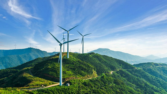 Wind turbines against a blue sky.