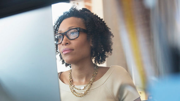 Zoomed in image of woman actively viewing content on external monitor screen