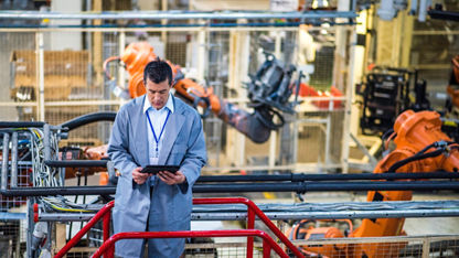 Engineer in a factory using a digital tablet