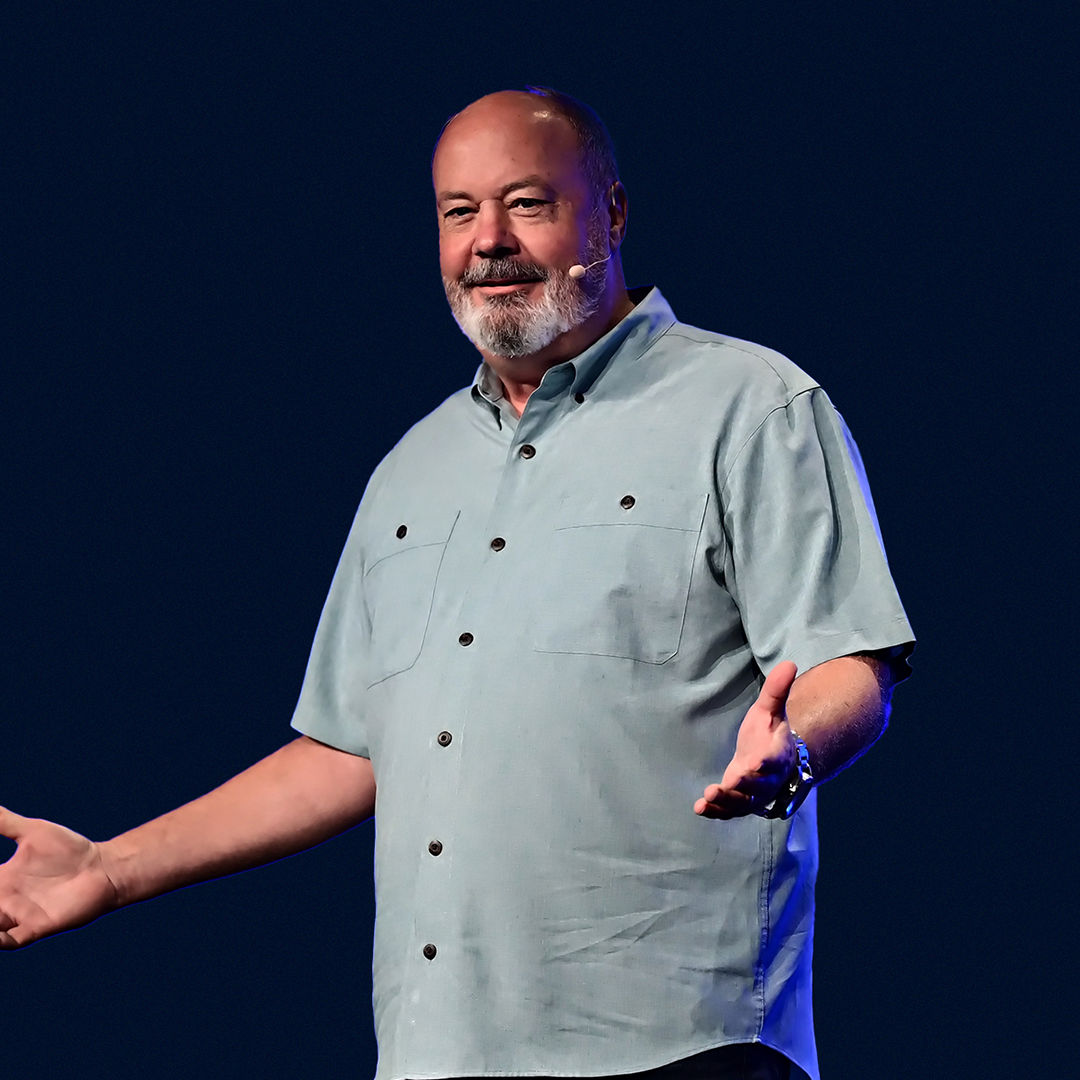 Image of Jim Johnson, Senior Vice President of Intel’s Client Computing Group, speaking animatedly at an event with a blue background behind him