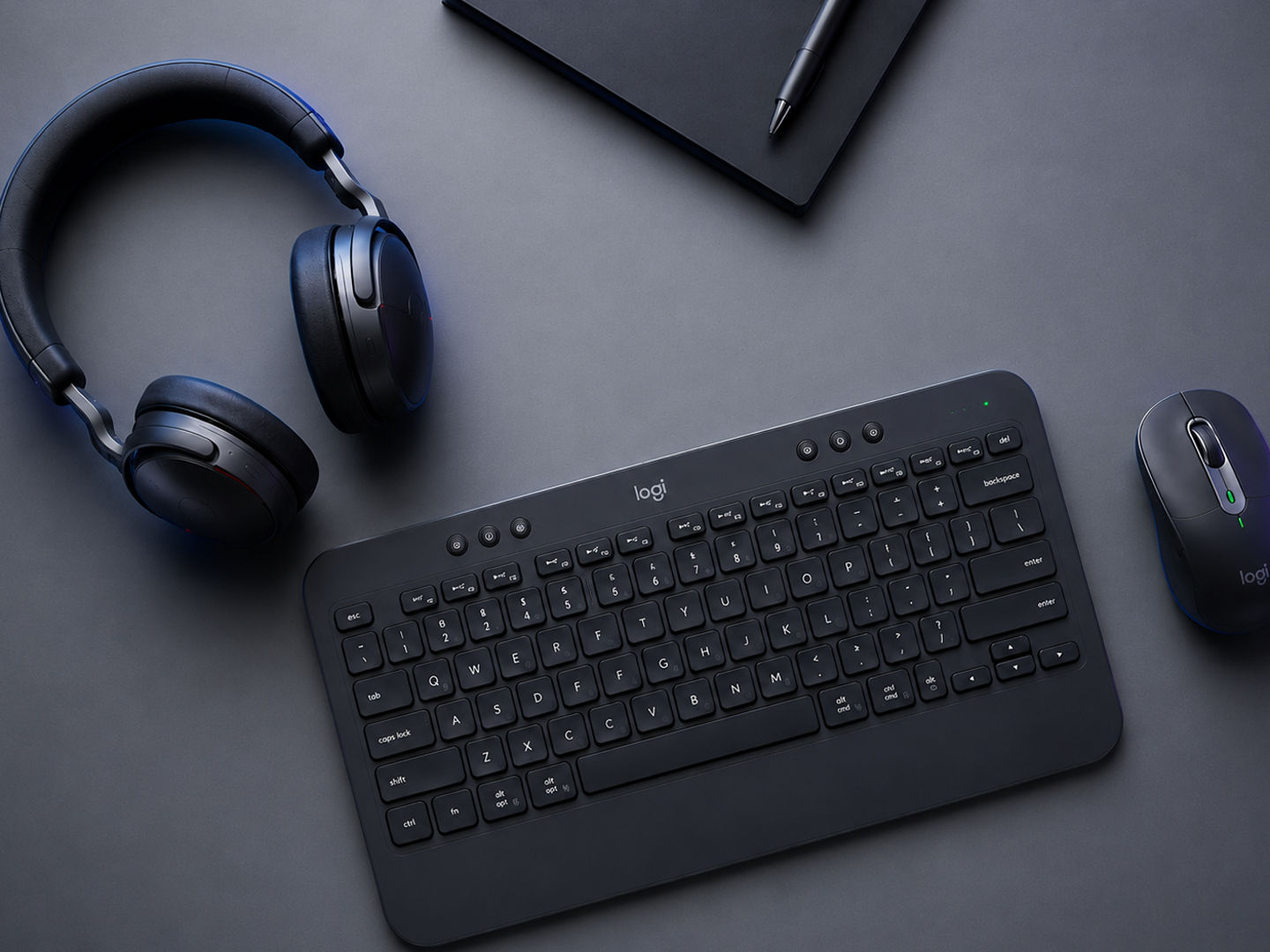 Desktop showing headphones, keyboard, mouse, and tablet.