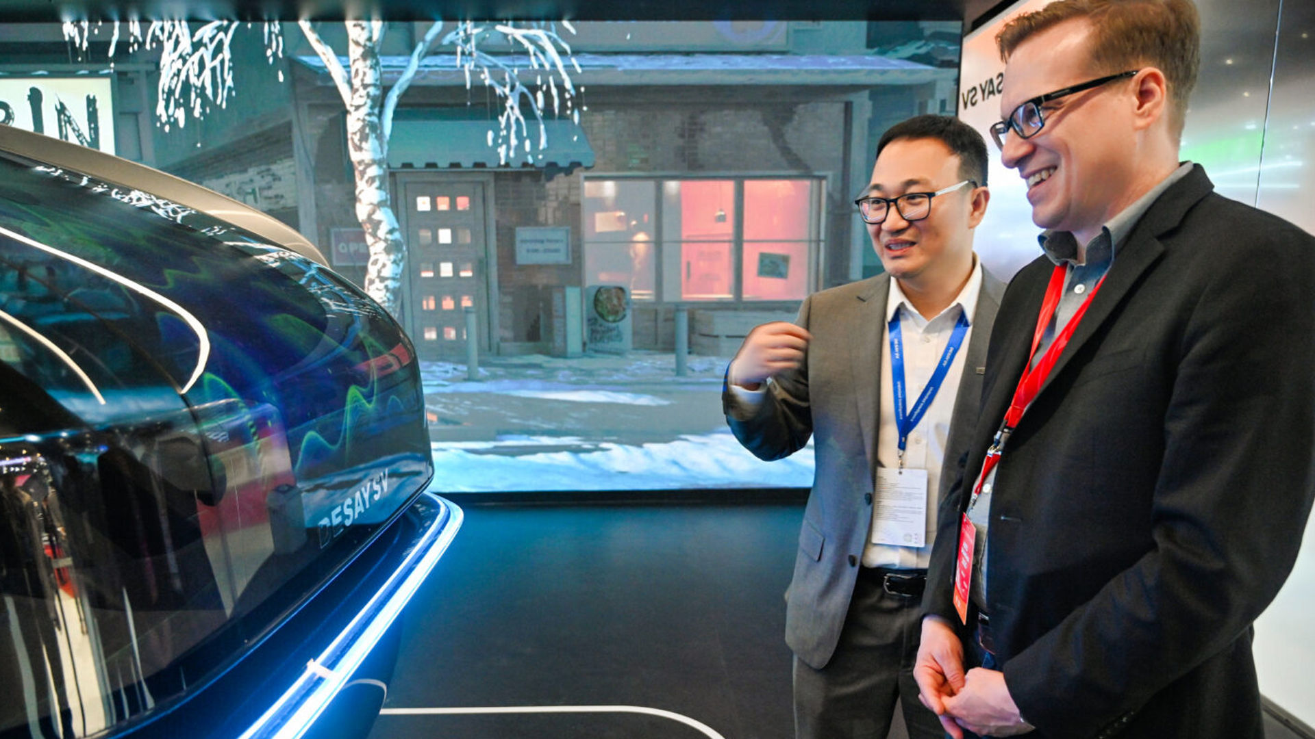 Jack Weast and a colleague view a Desay SV automotive display at Auto Shanghai.