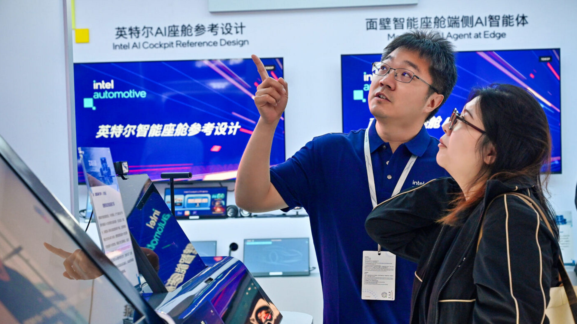 An Intel expert demonstrates automotive technology to a visitor at the Intel booth during Auto Shanghai.