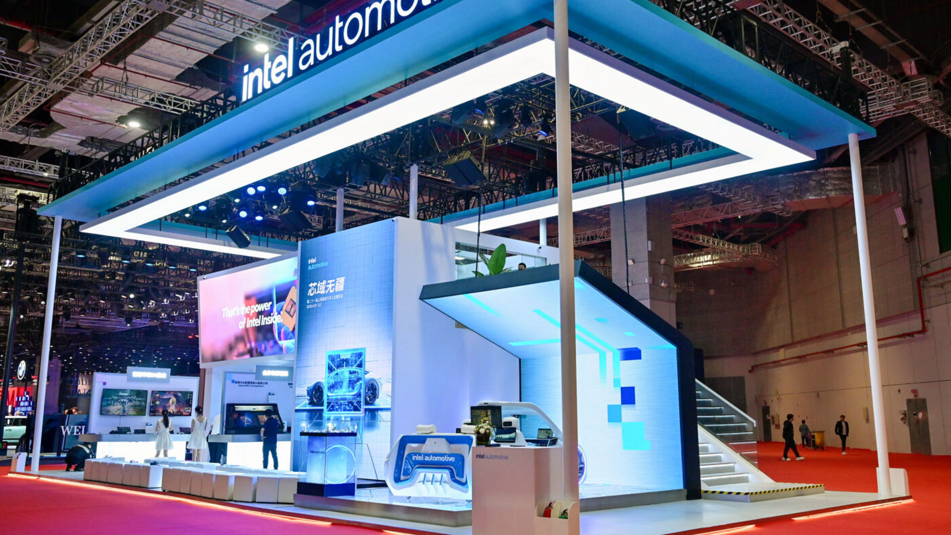 The Intel Automotive exhibition booth at Auto Shanghai featuring large digital displays and modern architecture.