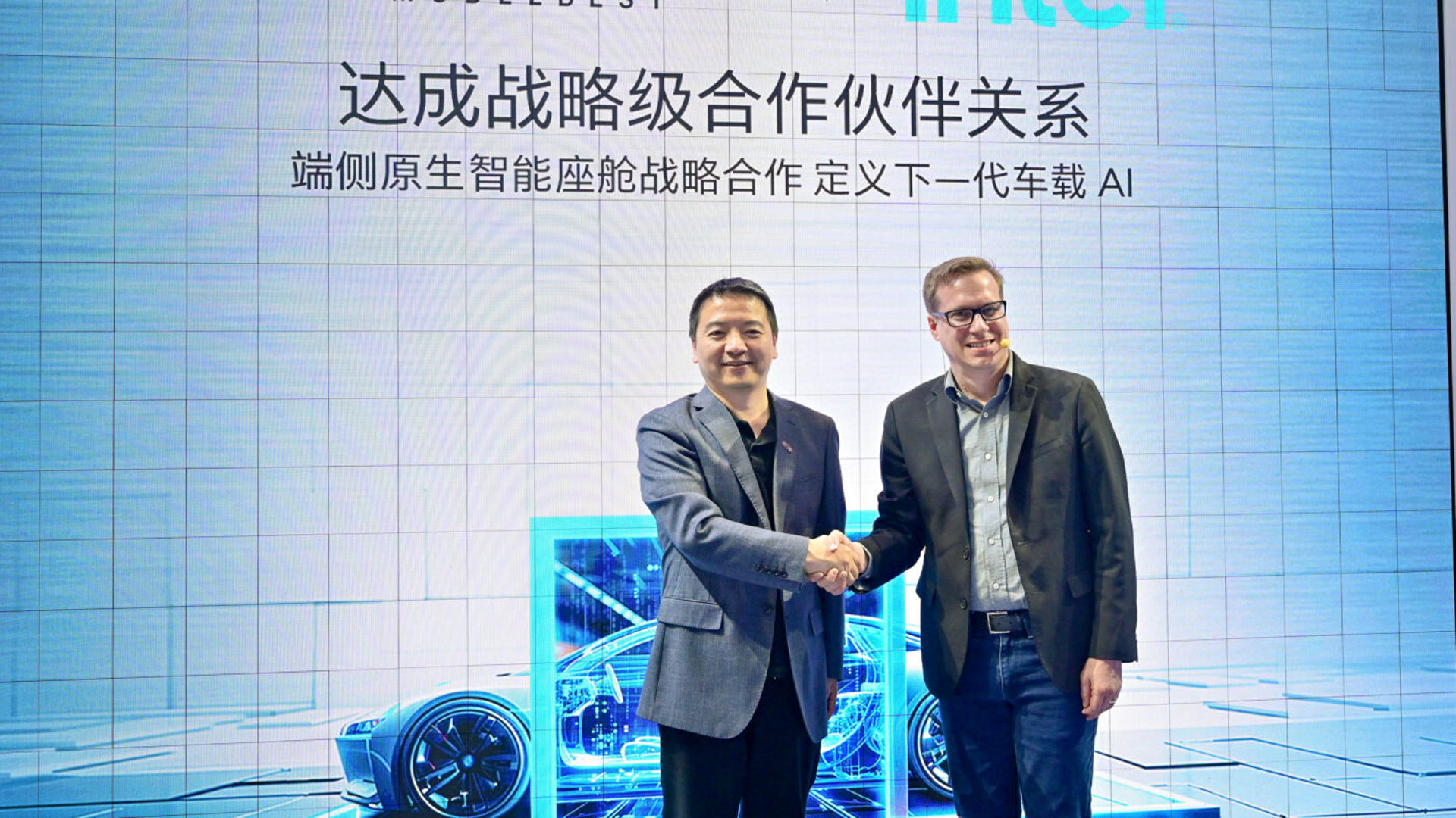 Jack Weast of Intel and a ModelBest executive shake hands at Auto Shanghai 2025.