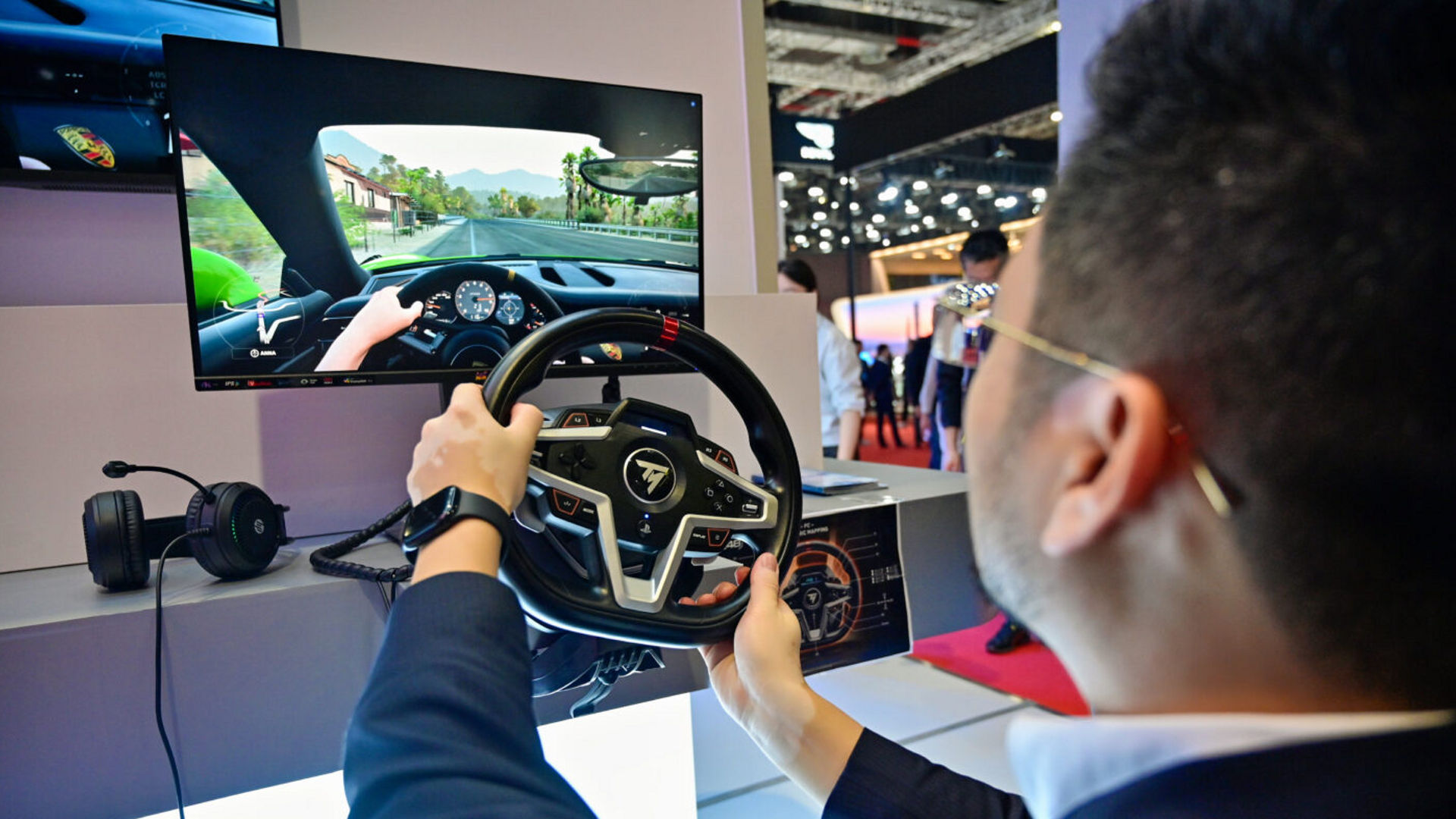 Yu Peng of XPeng uses a driving simulator at Auto Shanghai 2025.