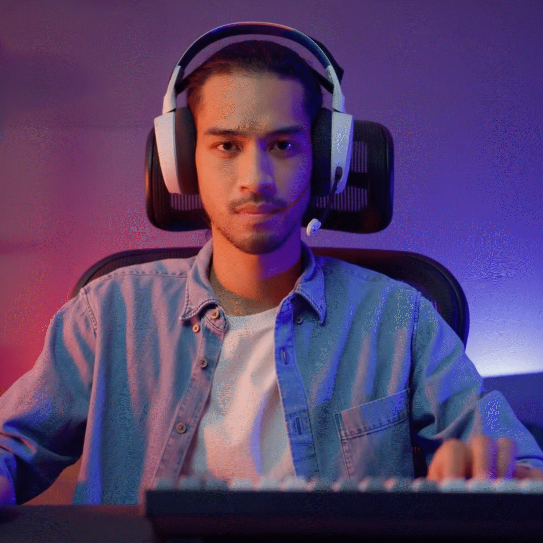 Video game player in headphones at keyboard