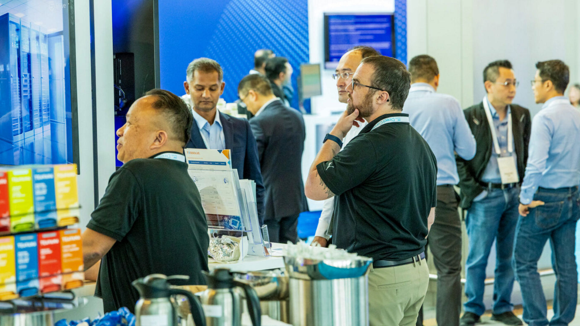 Attendees at Intel Foundry Direct Connect explore event displays and network.