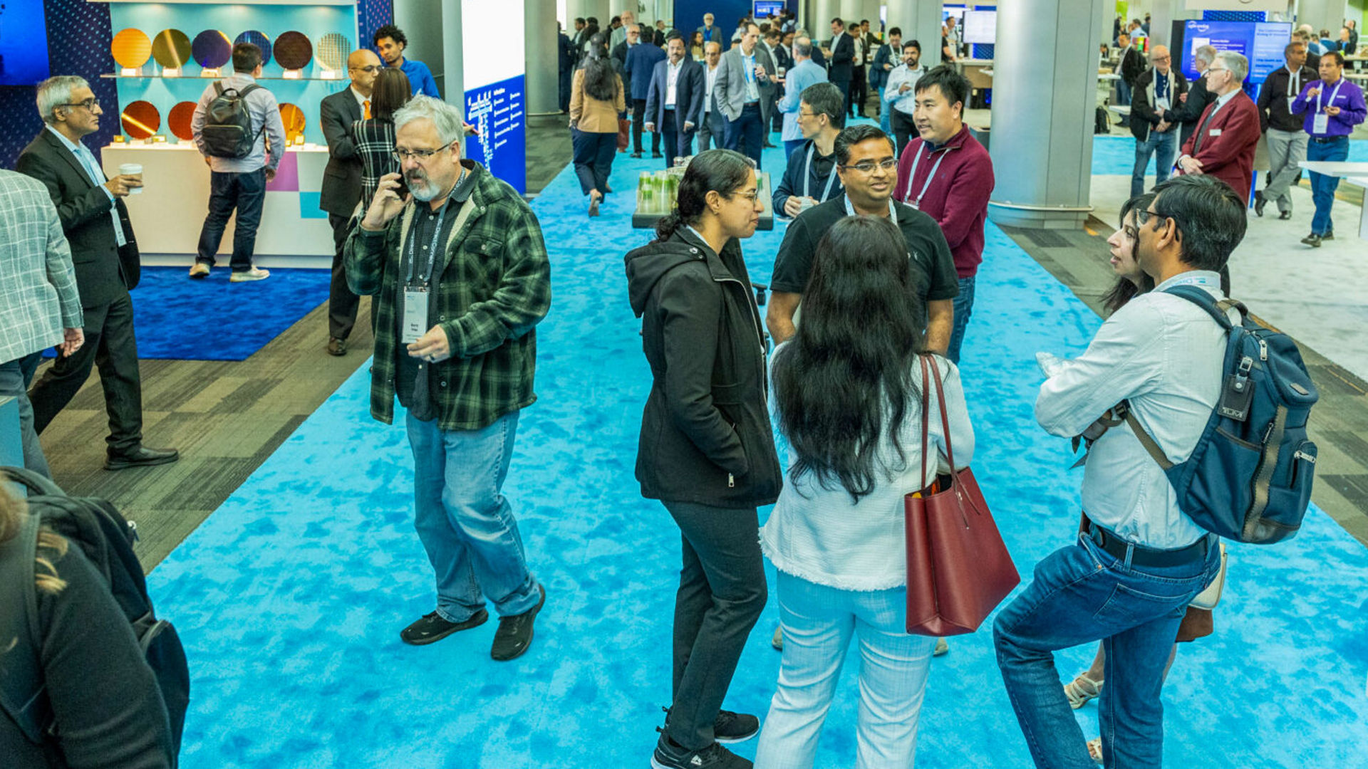 Attendees and partners networking on the event floor at Intel Foundry Direct Connect.