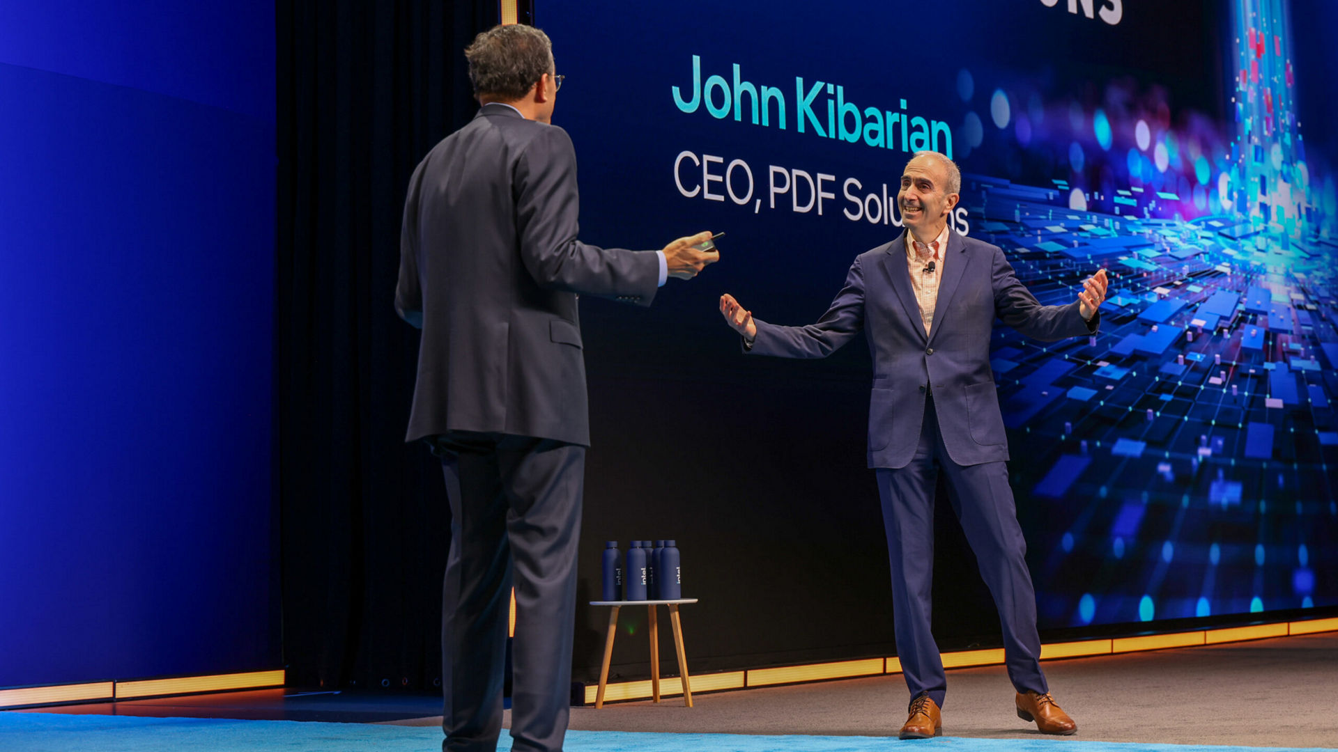 Lip-Bu Tan and John Kibarian speaking on stage at the Intel Foundry Direct Connect event.