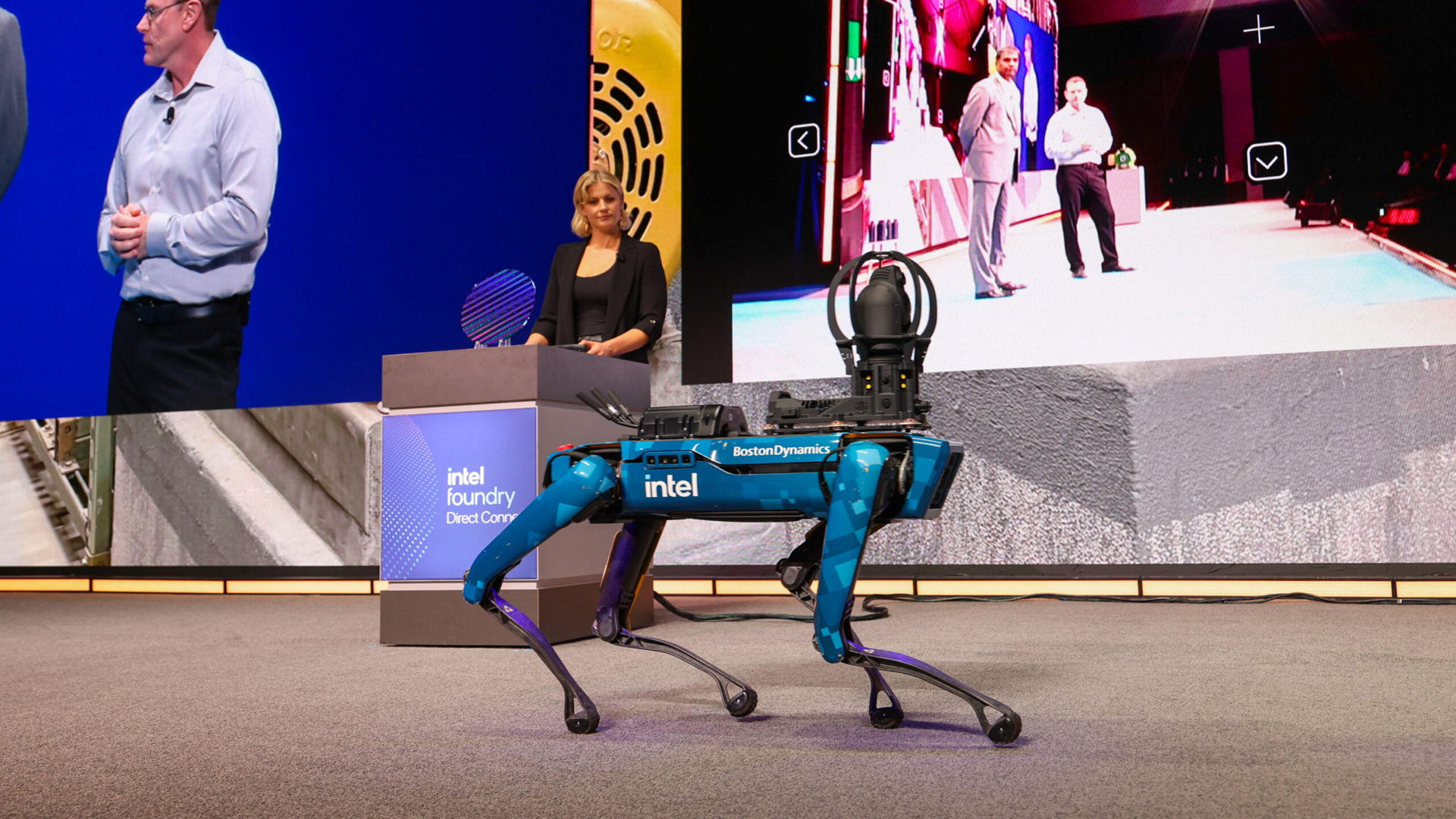 Jessica Unwin and a blue Intel-branded robot on stage at Intel Foundry Direct Connect.