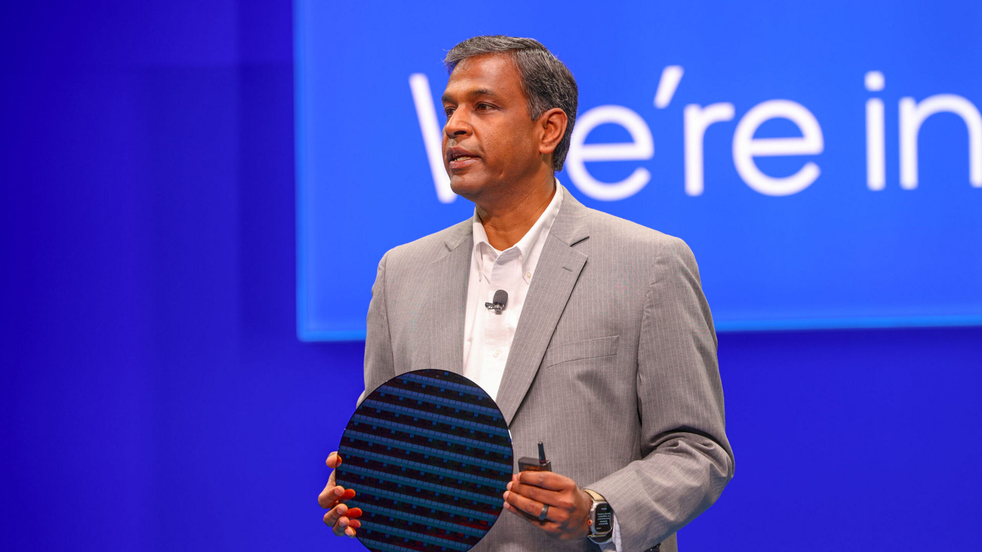 Naga Chandrasekaran holds an Intel 14A process node wafer during a keynote presentation.