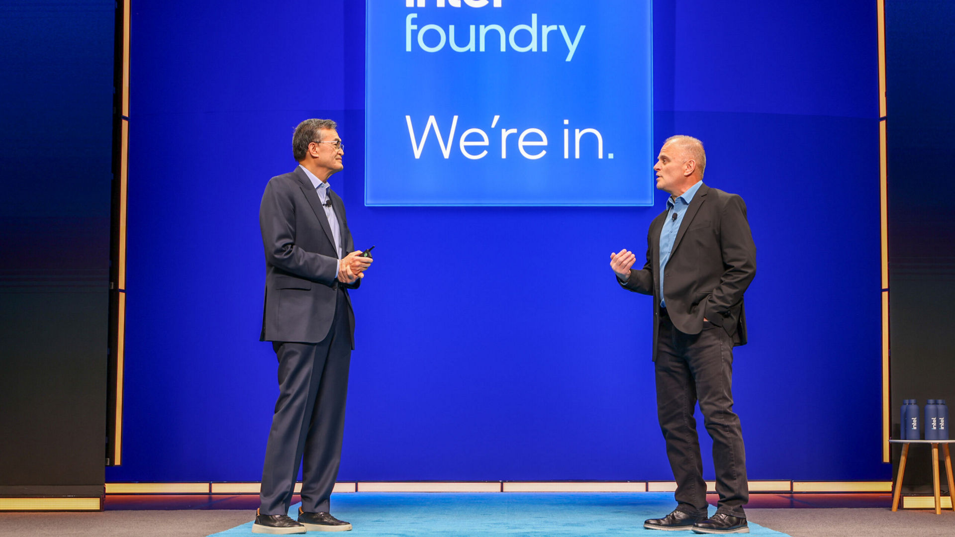 Lip-Bu Tan and Mike Ellow speaking on stage at an Intel Foundry event.