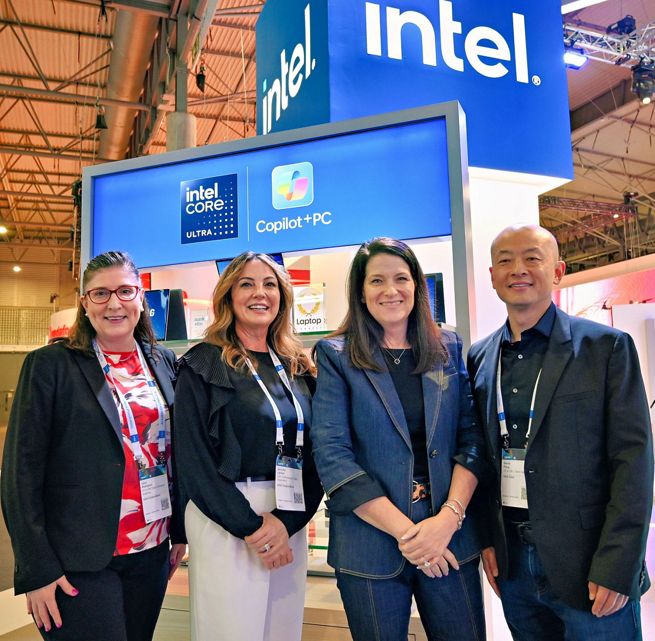 Intel leaders (from left) Carla Rodriguez, Jennifer Larson, Michelle Johnston Holthaus and David Feng pose at the Intel booth during Mobile World Congress 2025 in Barcelona, Spain. (Credit: Intel Corporation)