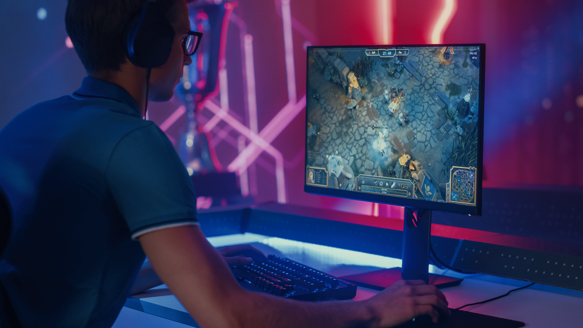 Person sitting at a desk playing a game on a display screen