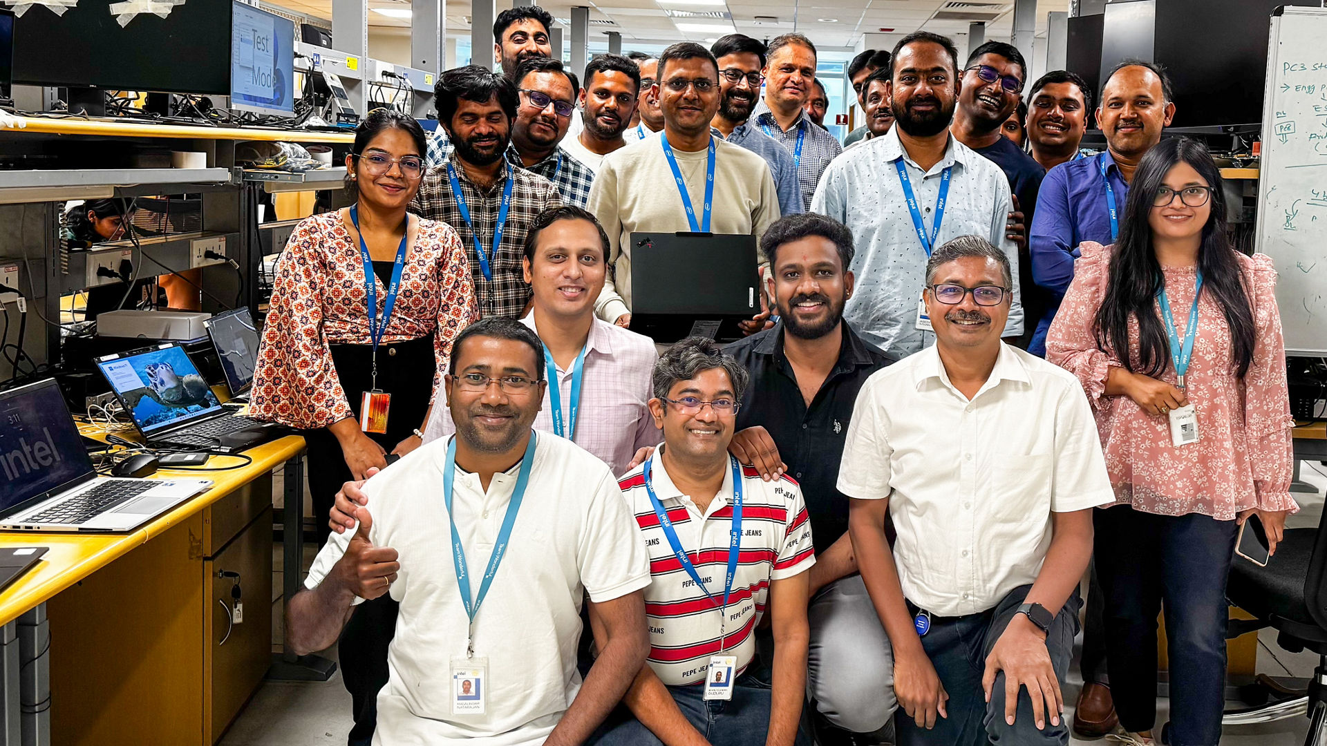 Bhavesh Shroff (center, holding the latest Lenovo Aura Edition PC), senior director of Platform Customer Engineering in the Client Computing Group at Intel, poses with the Intel team at the company’s engineering lab in Bengaluru, India, in April 2025. (Credit: Intel Corporation)