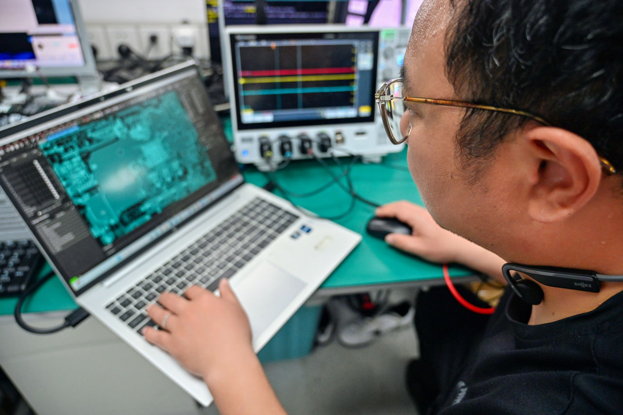 Hu Feng, systems and solutions engineer in the Client Computing Group at Intel in China, analyzes a schematic diagram at Intel’s engineering lab in Shanghai, China, in April 2025. (Credit: Intel Corporation)
