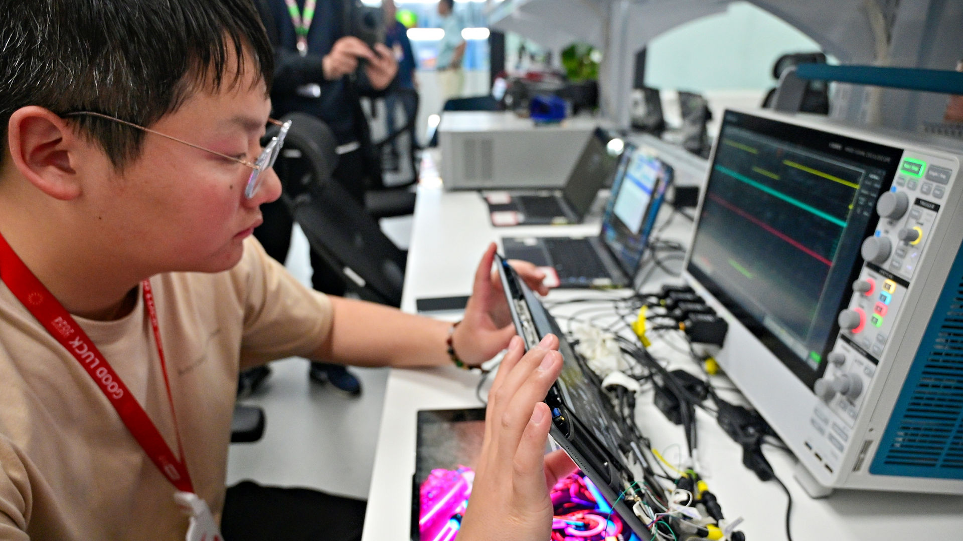 At Lenovo’s Advanced Co-Engineering Lab in Shanghai, China, Lenovo electronics engineer Xia Shengqiang analyzes the inner workings of a Lenovo Aura Edition PC in April 2025. (Credit: Intel Corporation)