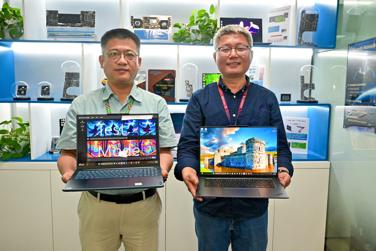 Zheng Jiong (left), senior director of Customer Engineering and Platform Center of Excellence in the Client Computing Group at Intel China, and Zhijian Mo, director of Platform Design and Development in the Intelligent Devices Group at Lenovo, show off Lenovo’s latest Aura Edition PCs in April 2025. (Credit: Intel Corporation)
