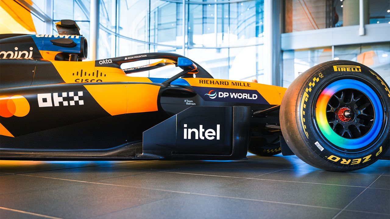 Side view of an orange and black McLaren Formula 1 race car featuring the Intel logo.
