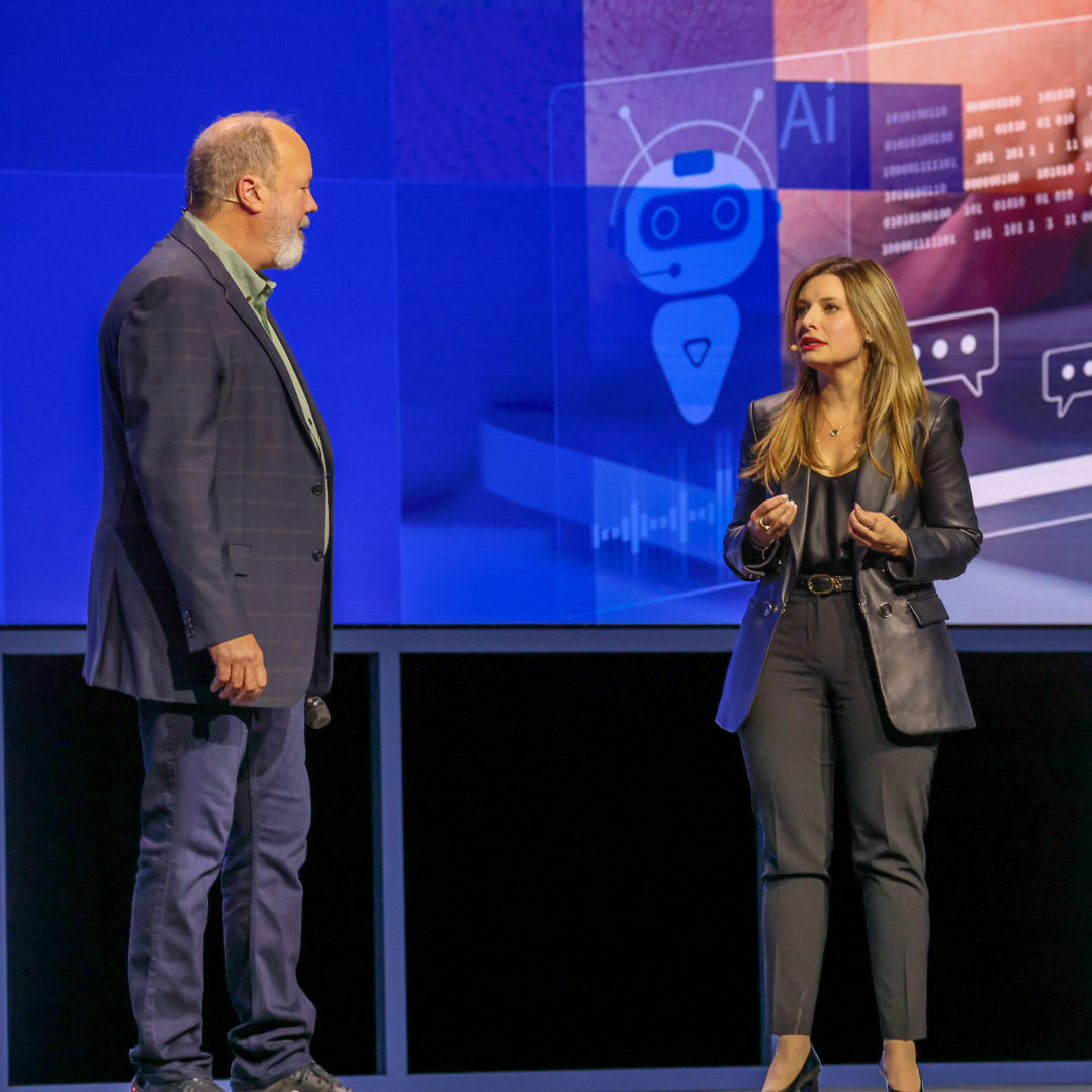 Dounia Senawi (right), Deloitte Consulting’s chief commercial officer, appears on stage with Jim Johnson, general manager of the Client Computing Group at Intel, during the Intel Vision event on Tuesday, April 1, 2025, in Las Vegas. Senawi discussed Deloitte’s strategic investment in a fleet of Intel Core Ultra AI PCs for its developers, and she reported the company has seen a 50% time savings in completing routine tasks. (Credit: Intel Corporation)
