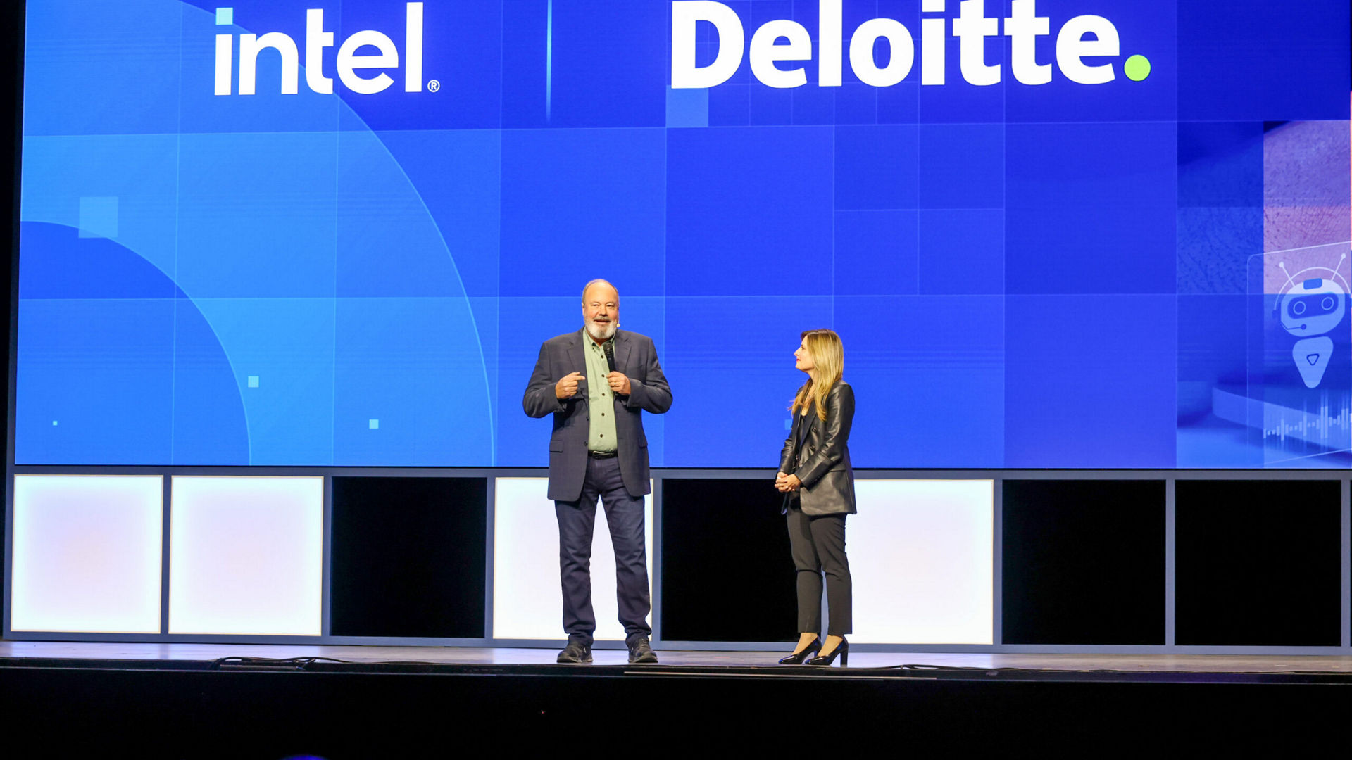 Dounia Senawi (right), Deloitte Consulting’s chief commercial officer, appears on stage with Jim Johnson, general manager of the Client Computing Group at Intel, during the Intel Vision event on Tuesday, April 1, 2025, in Las Vegas. Senawi discussed Deloitte’s strategic investment in a fleet of Intel Core Ultra AI PCs for its developers, and she reported the company has seen a 50% time savings in completing routine tasks. (Credit: Intel Corporation)