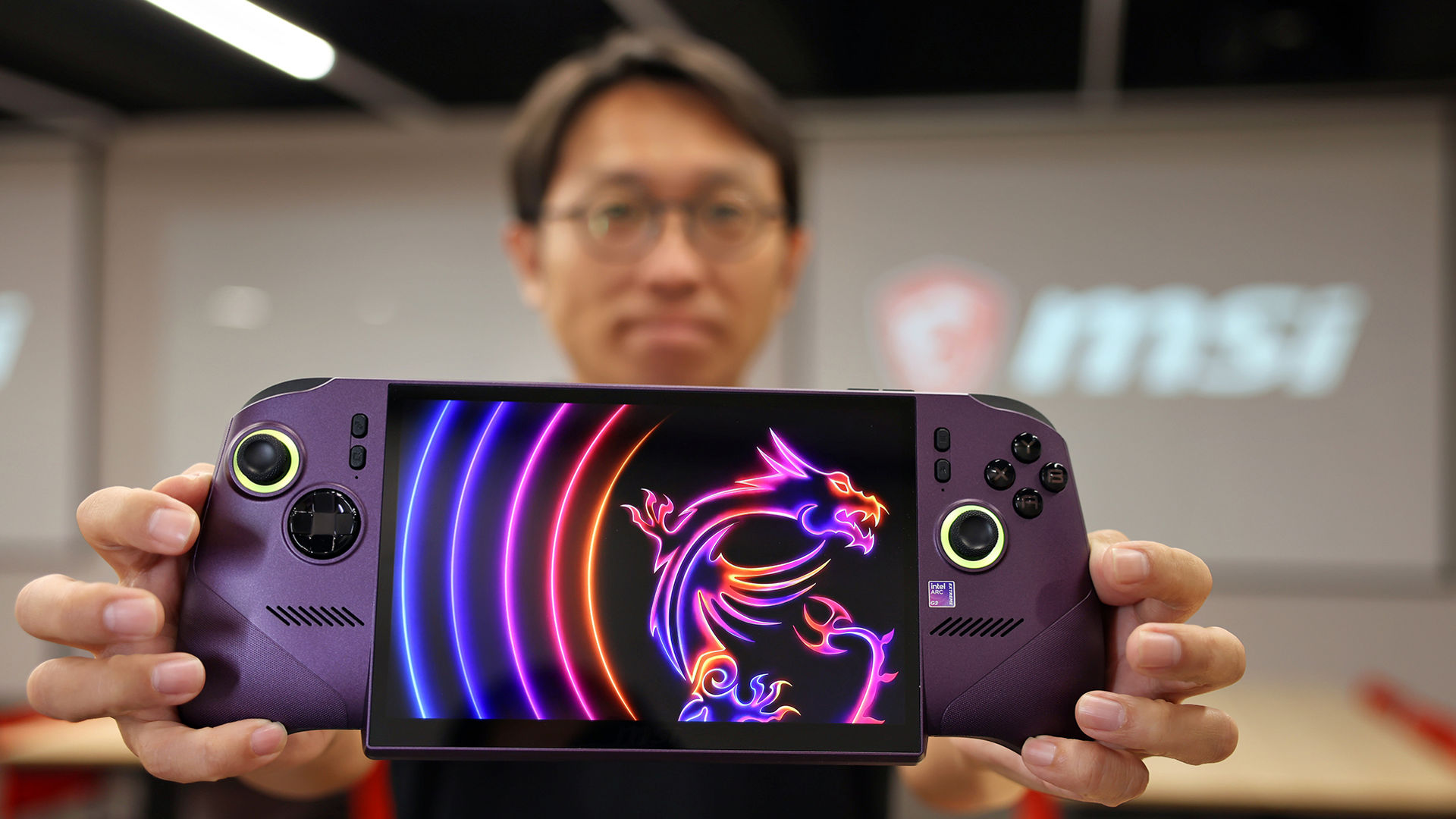 Joseph Shih of MSI shows the MSI Claw 8 EX AI+ handheld gaming device.