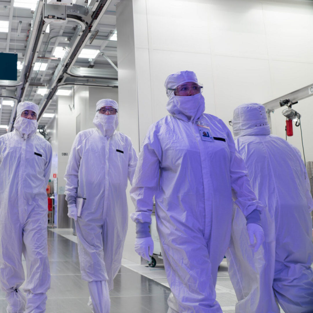 Intel manufacturing leaders, along with CEO Lip-Bu Tan (center) are gowned up in clean room bunny suits as they tour Fab 52 on the Intel Ocotillo campus in Chandler, Arizona in October 2025. Fab 52 is the U.S. home to Intel 18A, where Panther Lake, Intel’s next generation of consumer and client laptop processor, is being manufactured.