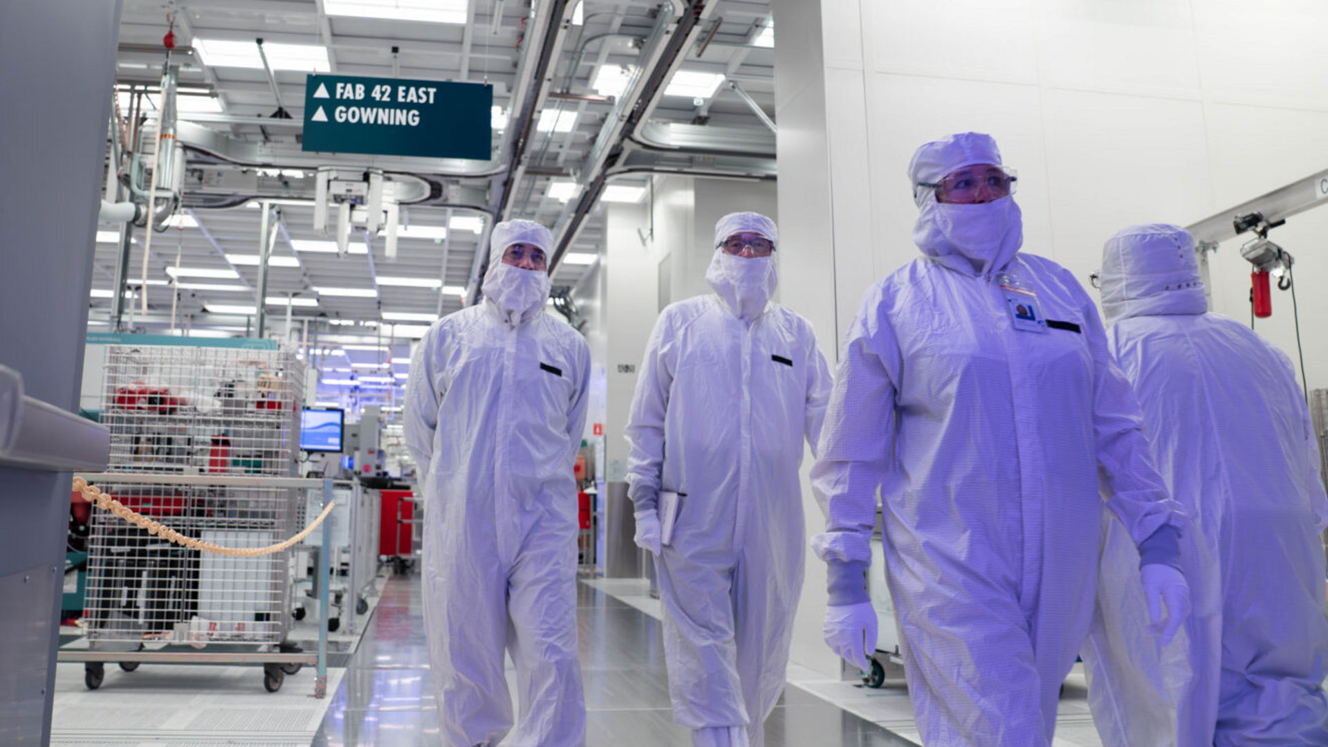 Lip-Bu Tan and Intel manufacturing leaders in cleanroom suits tour Intel Fab 52.