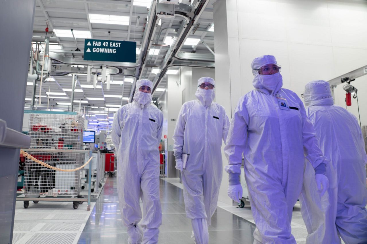 Intel manufacturing leaders, along with CEO Lip-Bu Tan (center) are gowned up in clean room bunny suits as they tour Fab 52 on the Intel Ocotillo campus in Chandler, Arizona in October 2025. Fab 52 is the U.S. home to Intel 18A, where Panther Lake, Intel’s next generation of consumer and client laptop processor, is being manufactured.
