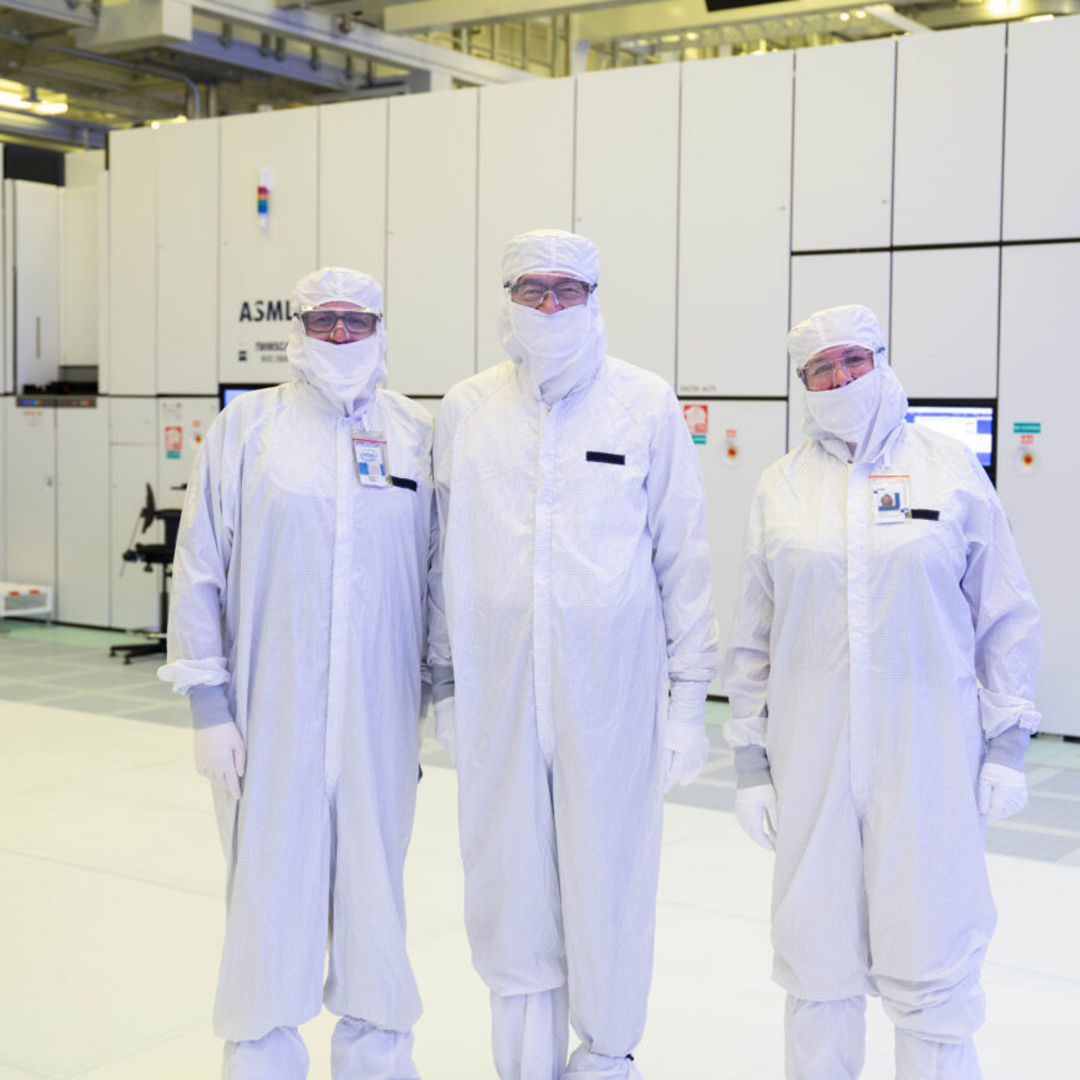 Intel CEO Lip-Bu Tan (center) stands with Jason Reid, Intel 18A Lithography Dept. Manager, (left) and Zivit Katz-Tsameret (right), Vice President, Intel Foundry Manufacturing and Supply Chain and Arizona Factory Manager, in front of an EUV lithography scanner used to print the next generation of Intel Core Ultra processors, code-named Panther Lake. Panther Lake is the first product to be manufactured on Intel 18A at Fab 52. Tan toured the Chandler, Arizona facility in October 2025.