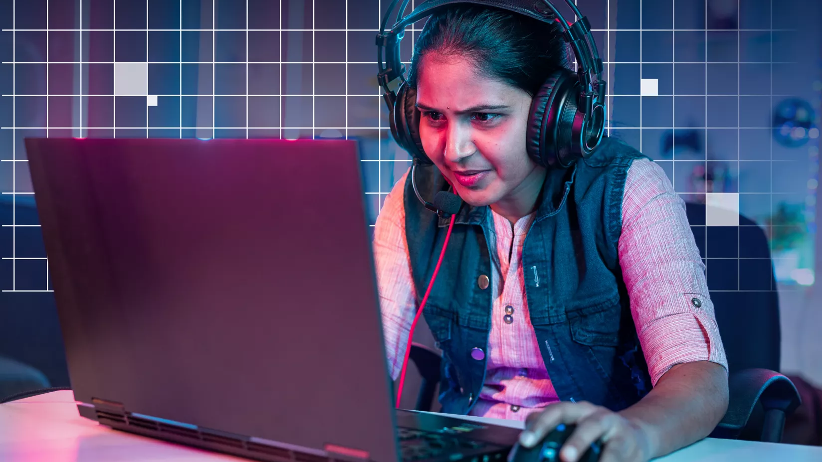 A gamer stares intently at a high-end gaming laptop screen while playing