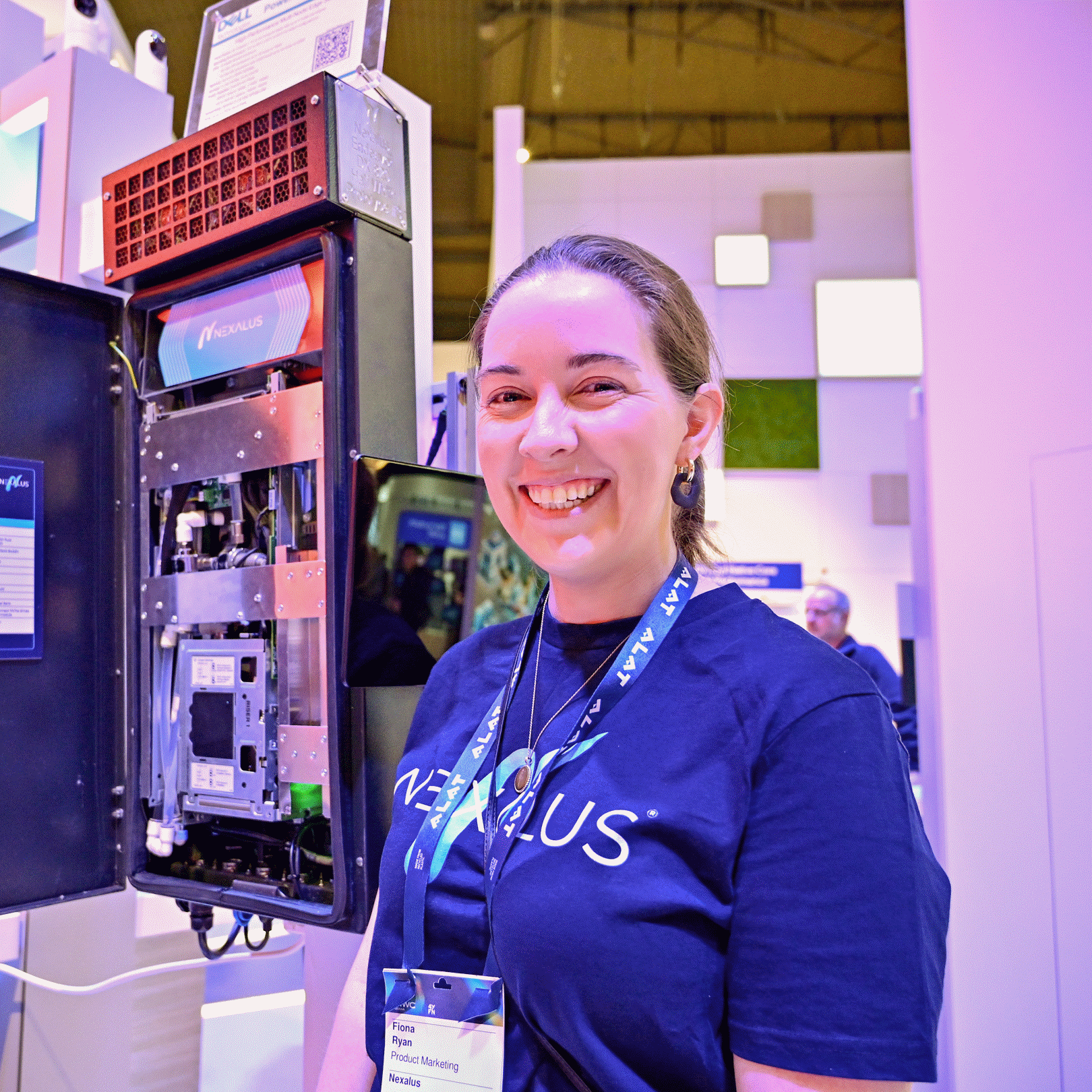 Fiona Ryan, product marketing manager at Nexalus, shows off the company’s IP66-certified all-weather ruggedized edge server at the Intel booth at Mobile World Congress in March 2025 in Barcelona, Spain. (Credit: Intel Corporation)