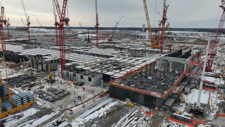 Aerial view of the Intel Ohio One construction site with cranes and concrete structures.