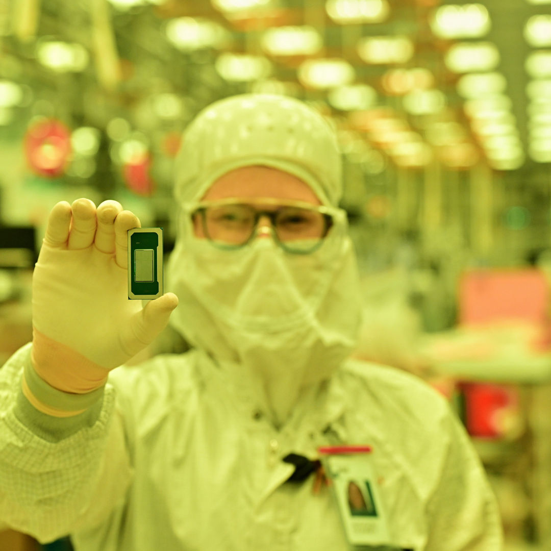 Technician holds an Intel Core Ultra series 3 processor.
