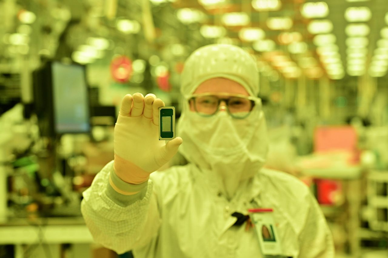 Technician holds an Intel Core Ultra series 3 processor.