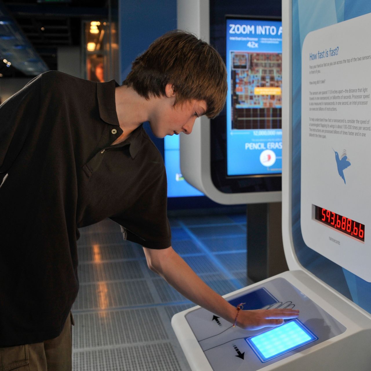 Young male visitor at display with keyboard